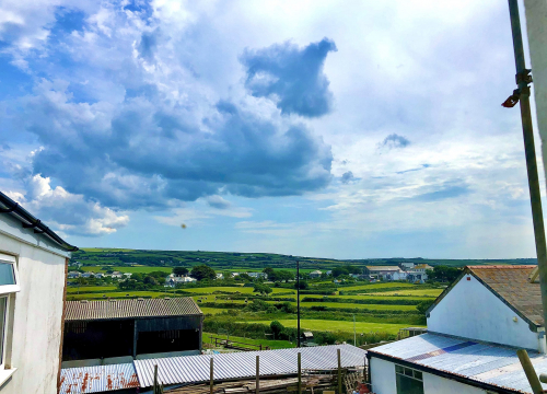 View from Pendrin across Cornish fields and hedgerows under a big cloud-filled sky