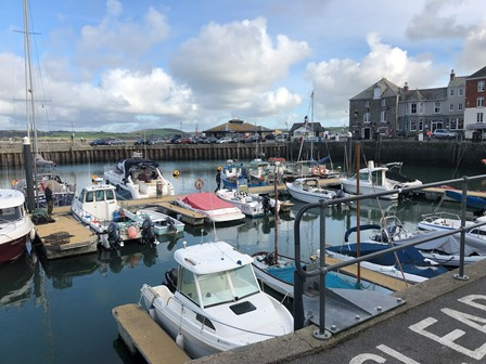 Small fishing and pleasure boats moored side by side in a sheltered Cornish harbour